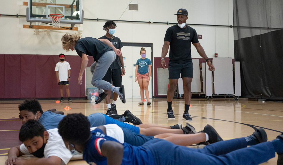 Elijah Muhammad looks on as LOFT students participate in a Crossfit workout.