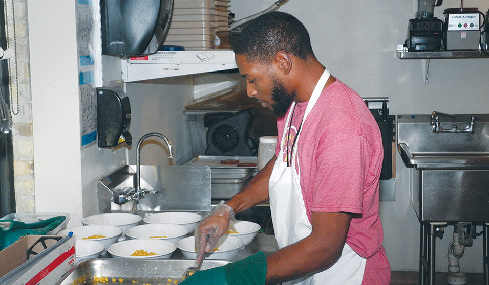 Jermel McLin works in the Goodman Community Center kitchen as lunch is prepared.