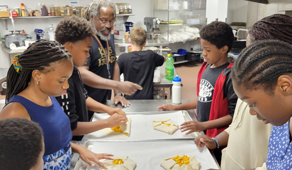 Howard Hayes of the Goodman Community Center instructs middle school youth on how to make peach galettes.