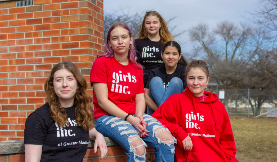 Girls Inc. participants from East High School pose as a group wearing Girls Inc. shirts.