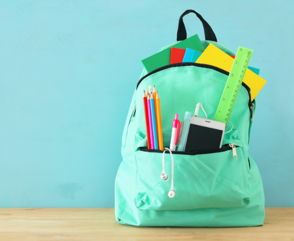 Photo of a green backpack with pencils, folders, phone and other school supplies poking out.