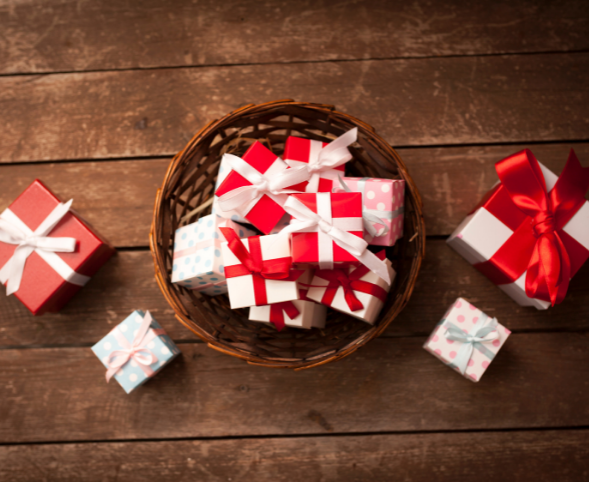 Red and white wrapped gifts in a basket.