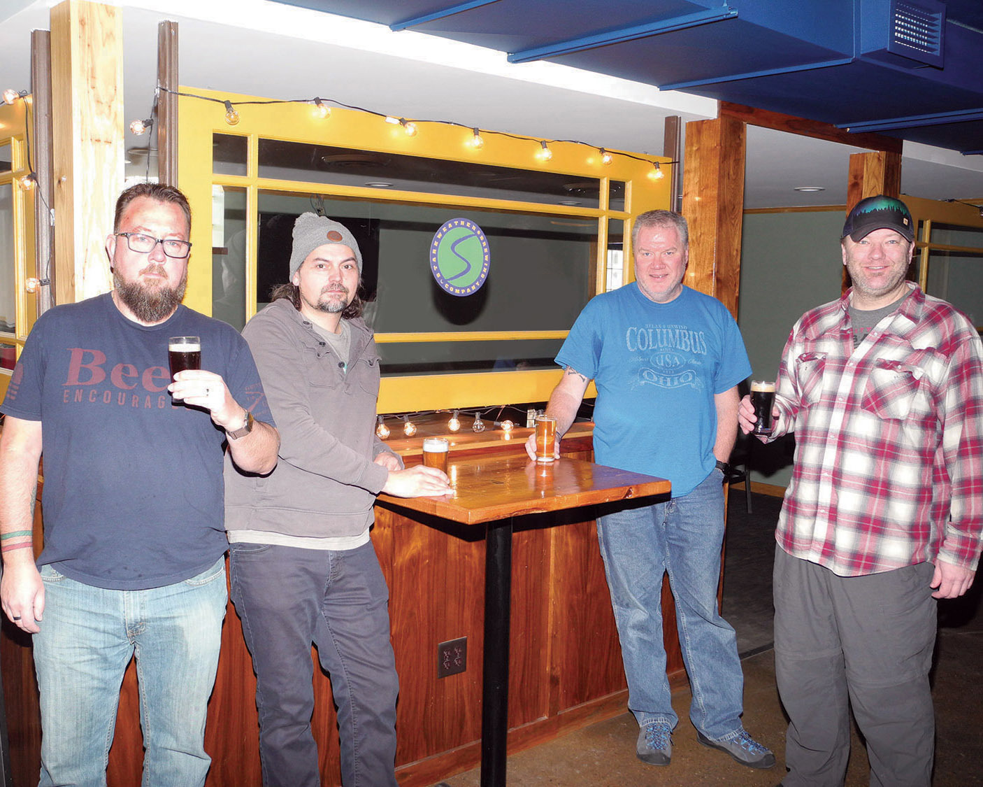 The owners in the tap room of Starkweather Brewing Company