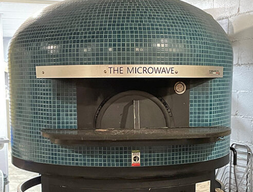 The wood-fired pizza oven named "The Microwave."