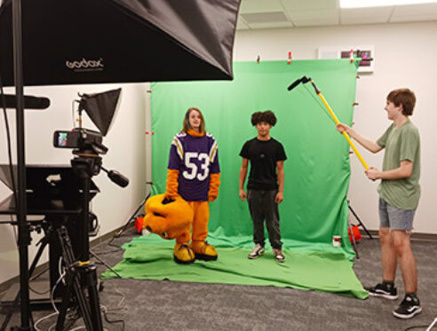 The student staff of "Tower TV" video tape a segment for an episode.