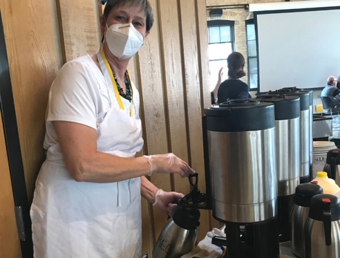 Nancy Resch volunteers in the Goodman Center older adult program. Here she fills a carafe of coffee.