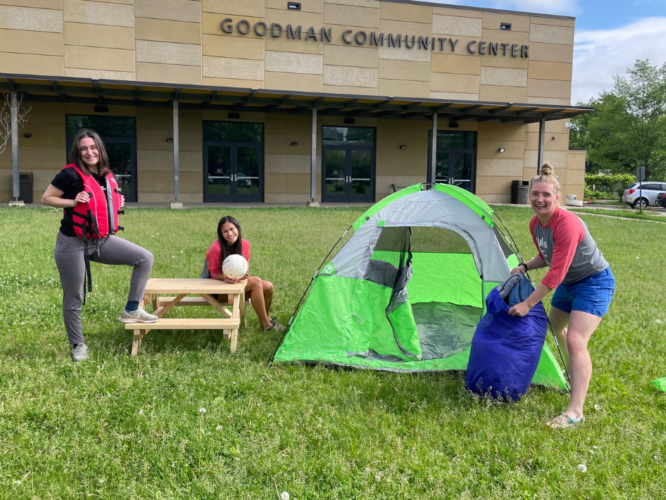 Girls Inc. of Greater Madison summer 2022 Adventure Camp counselors pose with a tent, sleeping bag, life jacket and volleyball.