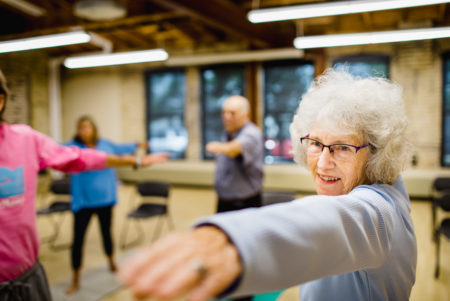 And older woman participates in easy yoga at the Goodman Center.