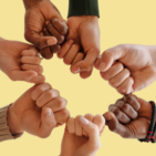 7 hands in fists connect to form the outline of a heart.